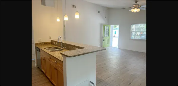 a kitchen that has a sink and a stove