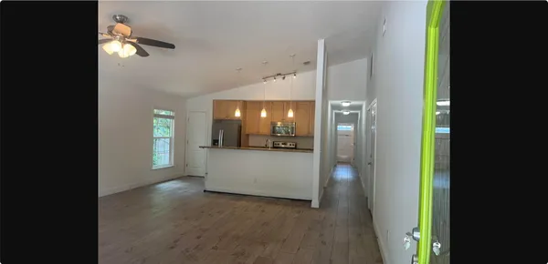 a view of an entryway and wooden floor