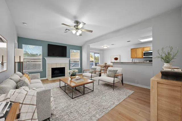 a living room with furniture a fireplace and a flat screen tv