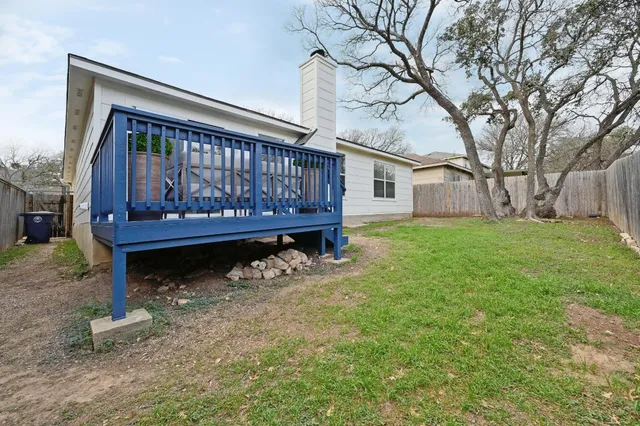 a view of a house with a yard from a patio