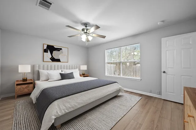 a bedroom with a large bed and a window