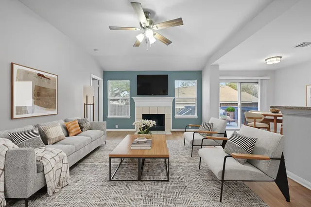 a living room with furniture a fireplace and a flat screen tv