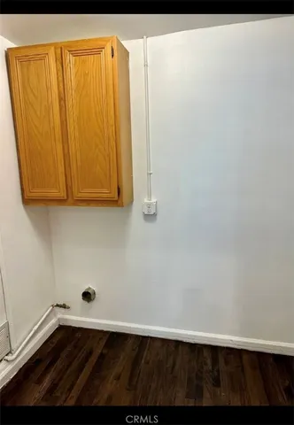 a view of a refrigerator with wooden floor