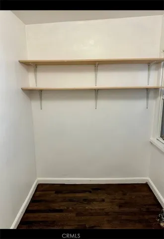 a view of a room with wooden floor