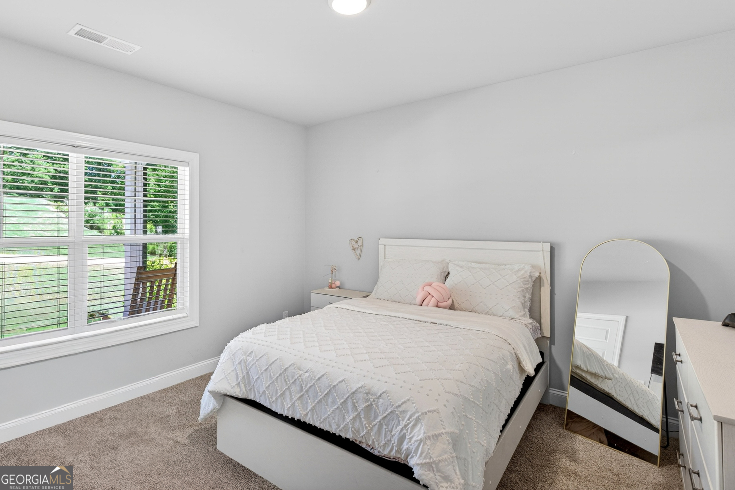 1764 Luther Bailey Road Senoia, GA 30276 - Photo 28 of 63 a bedroom with a large bed and a window