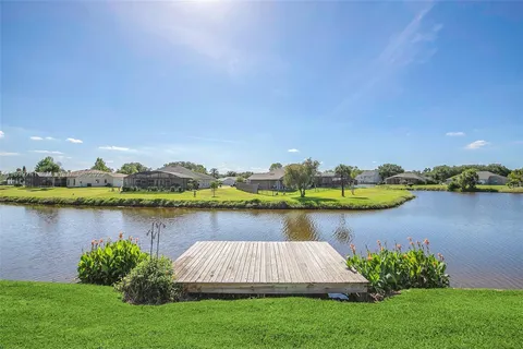 a view of a lake with houses in the back