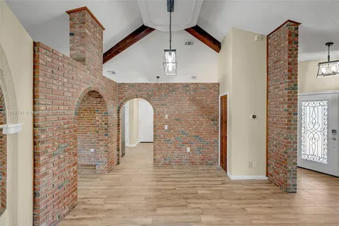 a view of empty room with wooden floor and ceiling fan