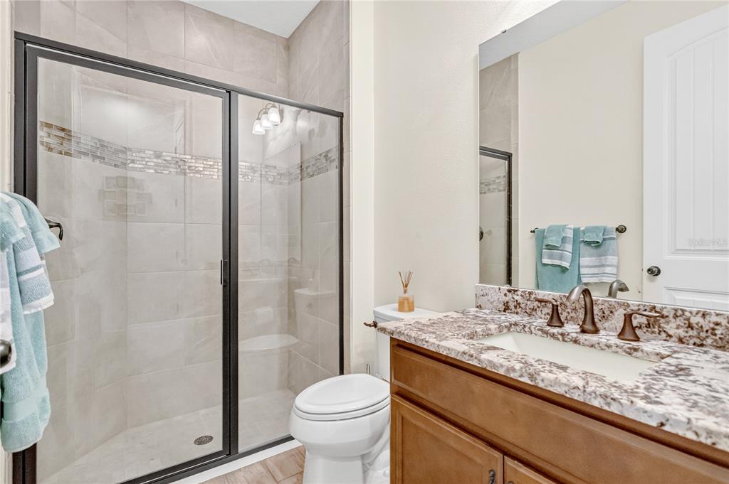 9009 Palm Key Avenue Oldsmar, FL 34677 - Photo 12 of 38 a bathroom with a granite countertop sink toilet and shower