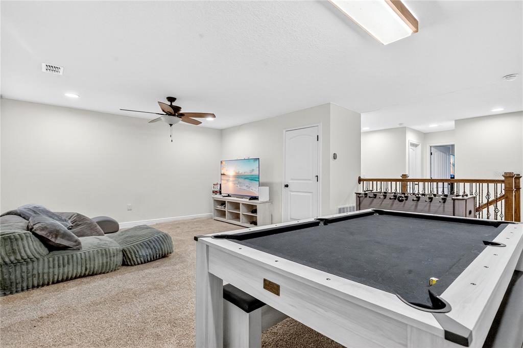 9009 Palm Key Avenue Oldsmar, FL 34677 - Photo 13 of 38 a living room with furniture pool table and a window