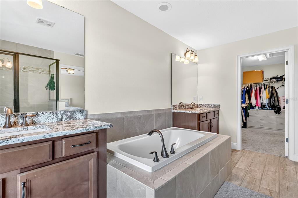 9009 Palm Key Avenue Oldsmar, FL 34677 - Photo 16 of 38 a bathroom with a tub sink and mirror