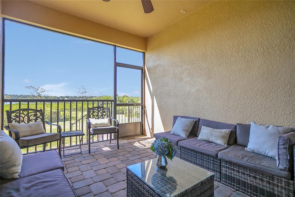 9009 Palm Key Avenue Oldsmar, FL 34677 - Photo 21 of 38 a living room with furniture and a floor to ceiling window