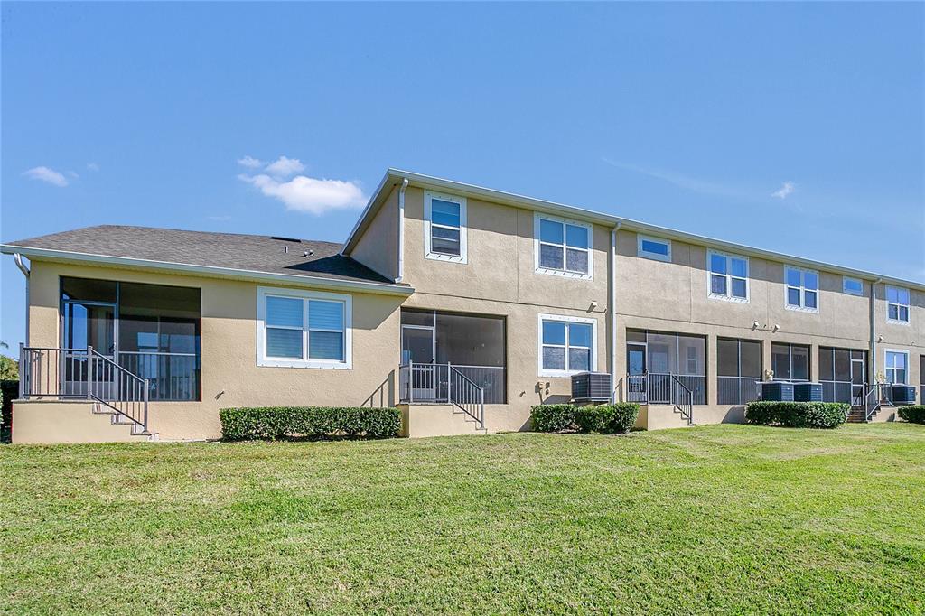 9009 Palm Key Avenue Oldsmar, FL 34677 - Photo 22 of 38 a front view of a house with a yard and potted plants