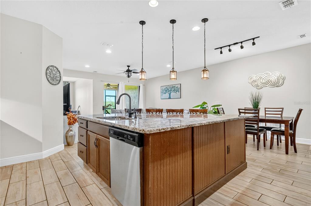 9009 Palm Key Avenue Oldsmar, FL 34677 - Photo 8 of 38 a kitchen with stainless steel appliances granite countertop a sink and a wooden floors