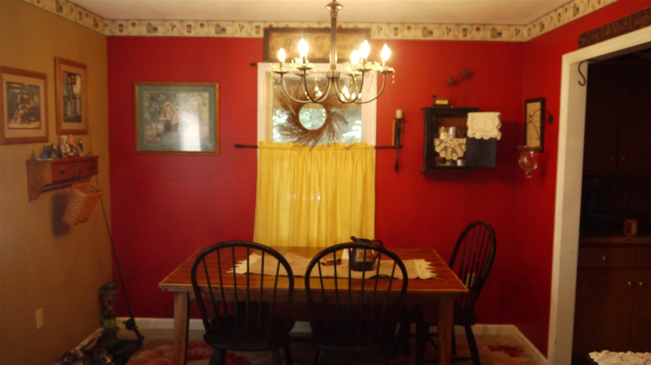 8877 Briery Branch Road Dayton, VA 22821 - Photo 2 of 12 a view of a dining room with furniture and chandelier