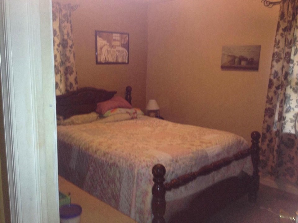 8877 Briery Branch Road Dayton, VA 22821 - Photo 6 of 12 a bed sitting in a bedroom next to a wall