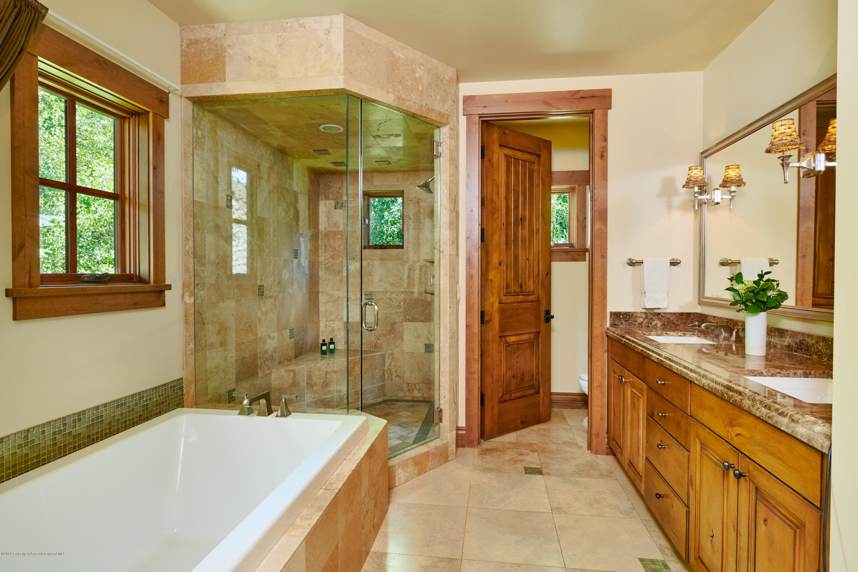 642 Holland Hills Road Basalt, CO 81621 - Photo 12 of 27 a spacious bathroom with a granite countertop tub shower and a sink