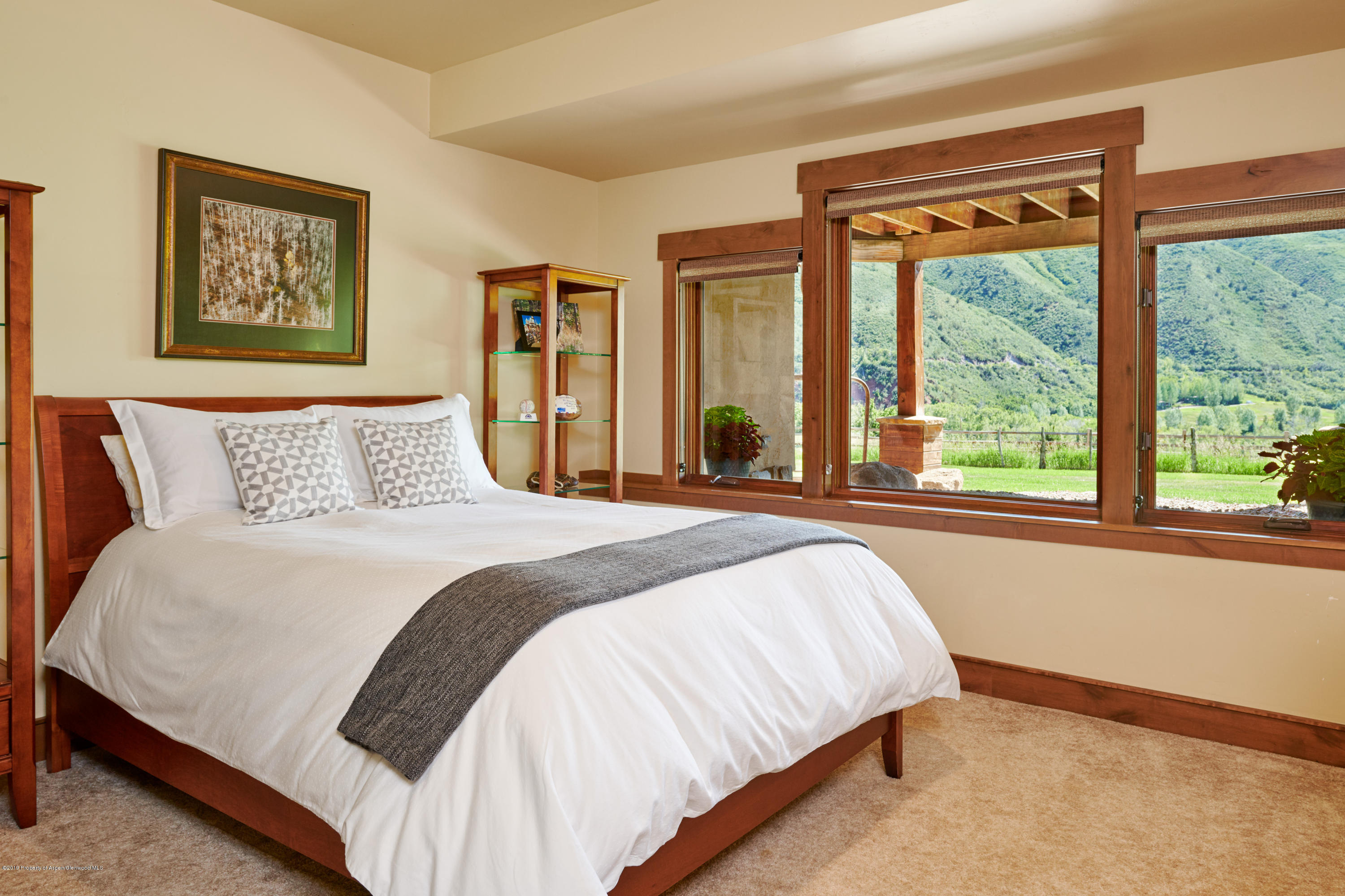 642 Holland Hills Road Basalt, CO 81621 - Photo 16 of 27 a bedroom with a large bed and a window