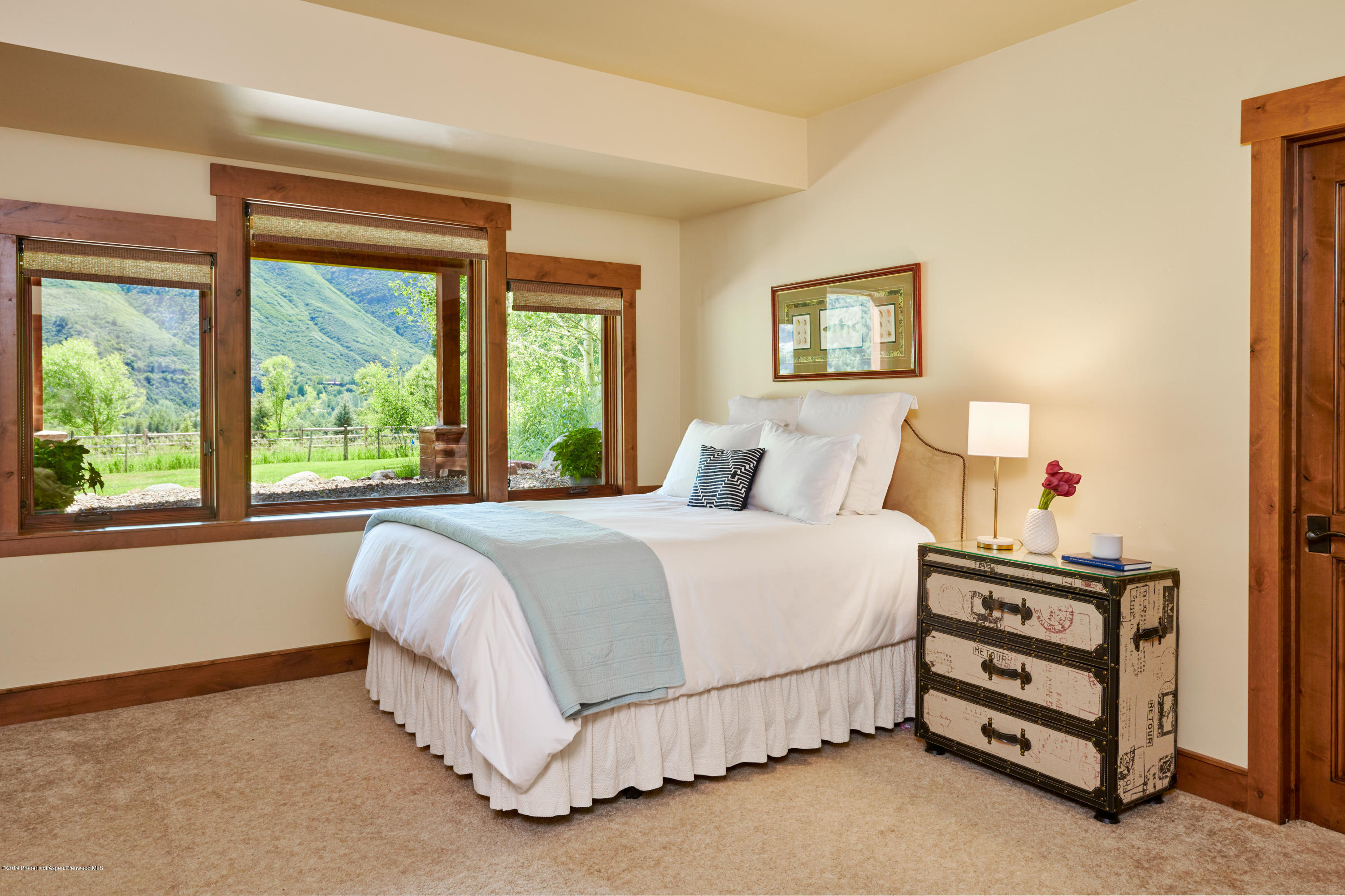 642 Holland Hills Road Basalt, CO 81621 - Photo 17 of 27 a bedroom with a bed and a window