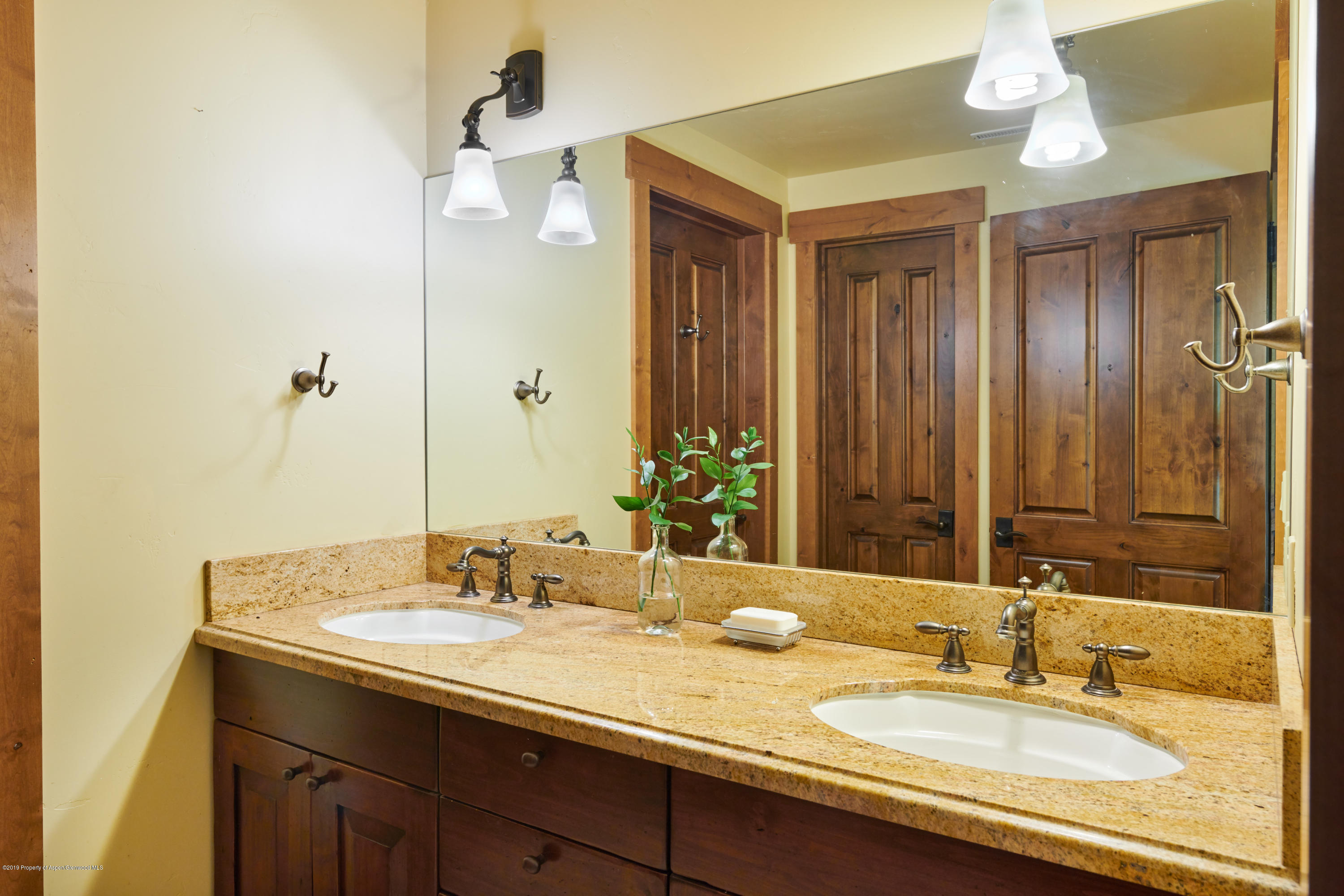 642 Holland Hills Road Basalt, CO 81621 - Photo 18 of 27 a bathroom with a granite countertop sink and a mirror