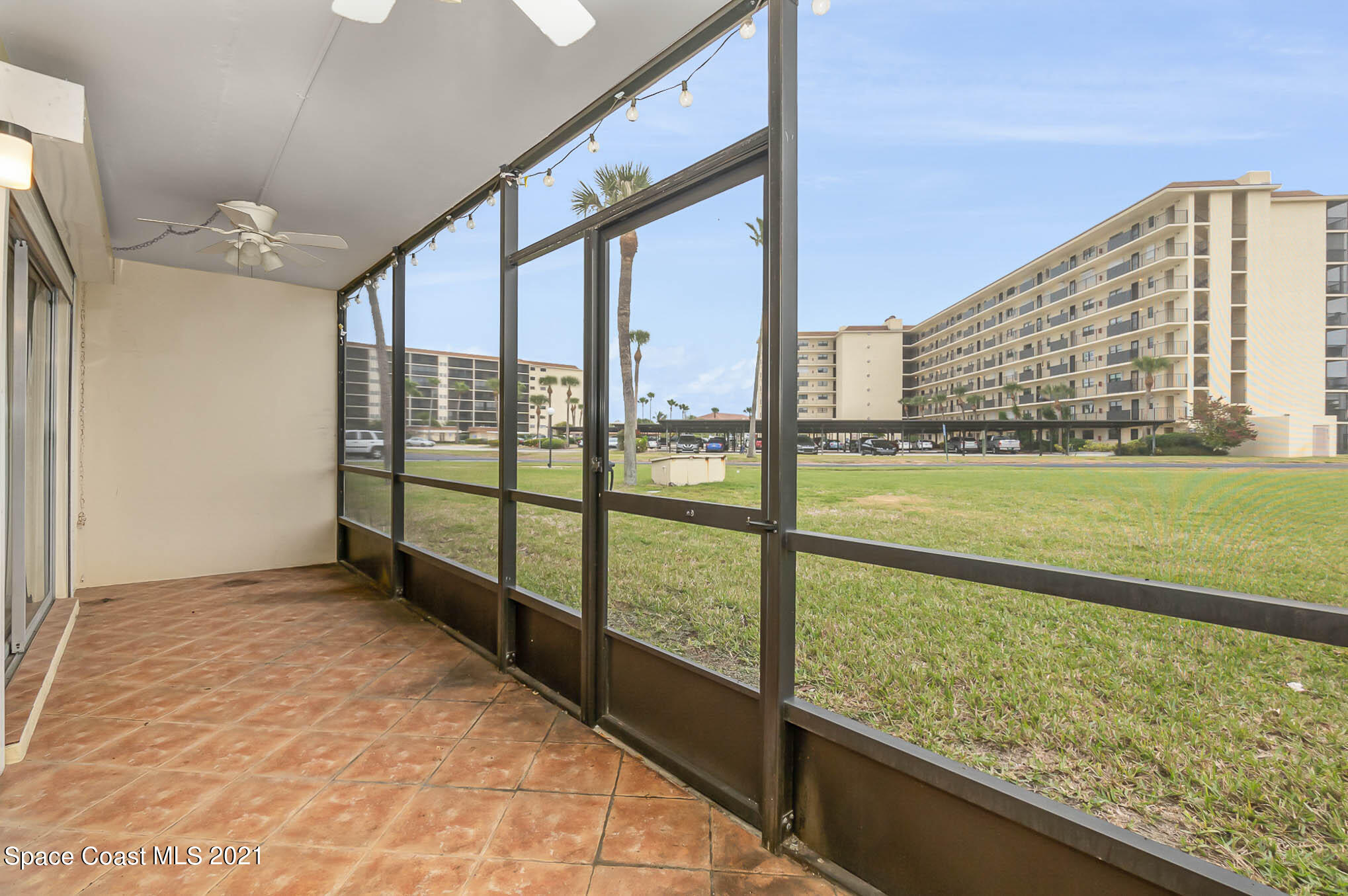 416 School Road, Unit 102 Indian Harbour Beach, FL 32937 - Photo 13 of 27 a view of an empty room with a floor to ceiling window and an outdoor view
