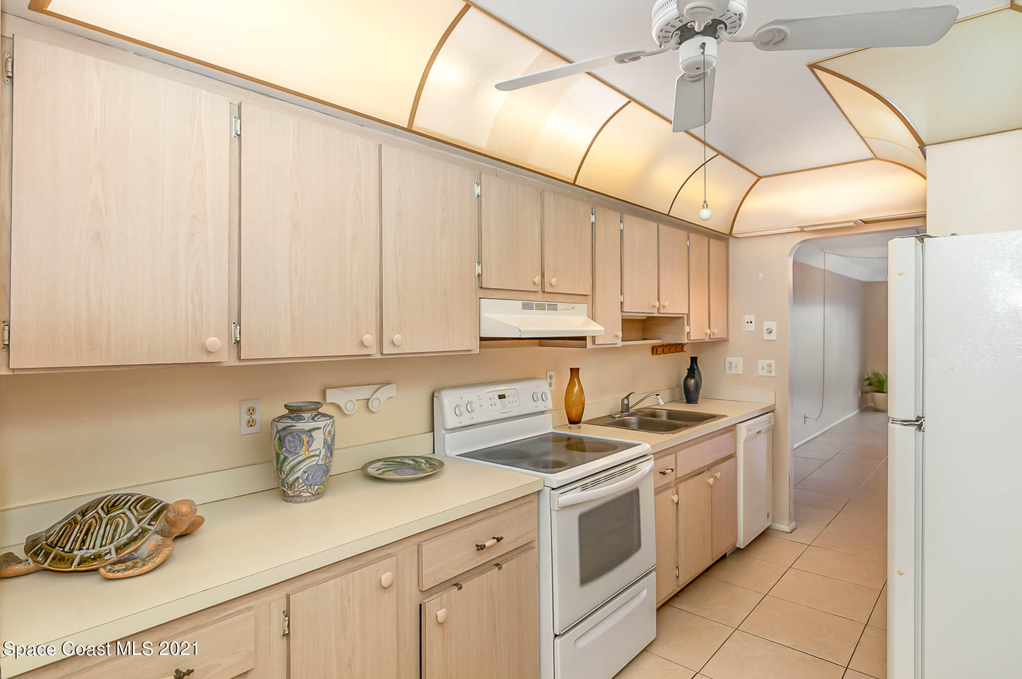 416 School Road, Unit 102 Indian Harbour Beach, FL 32937 - Photo 5 of 27 a kitchen with stainless steel appliances granite countertop a sink a stove and cabinets