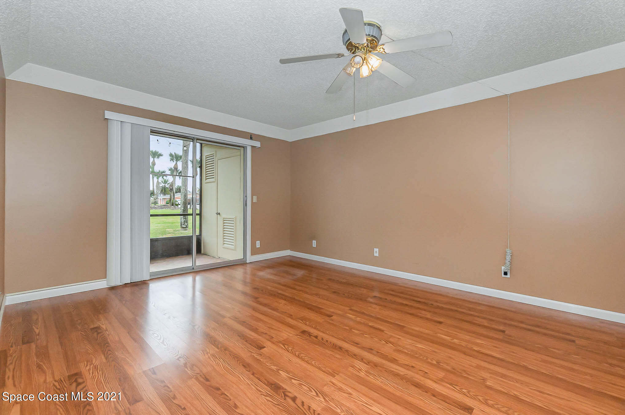 416 School Road, Unit 102 Indian Harbour Beach, FL 32937 - Photo 6 of 27 wooden floor in an empty room with a window