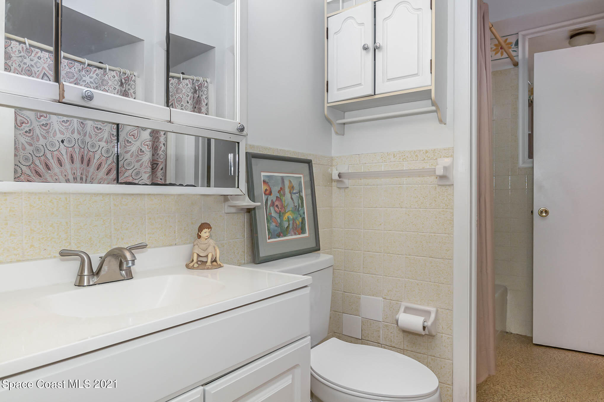 416 School Road, Unit 102 Indian Harbour Beach, FL 32937 - Photo 8 of 27 a bathroom with a sink toilet and vanity