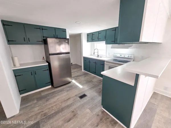 a kitchen with a refrigerator and a sink