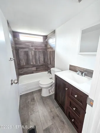 a spacious bathroom with a bathtub shower sink mirror vanity and toilet