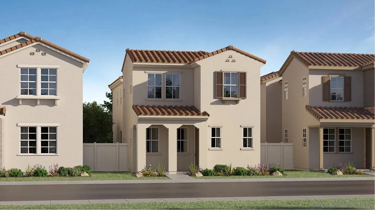 a front view of a house with a yard and parking space