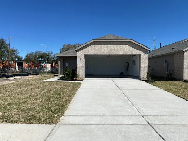 a view of a grey house with a yard