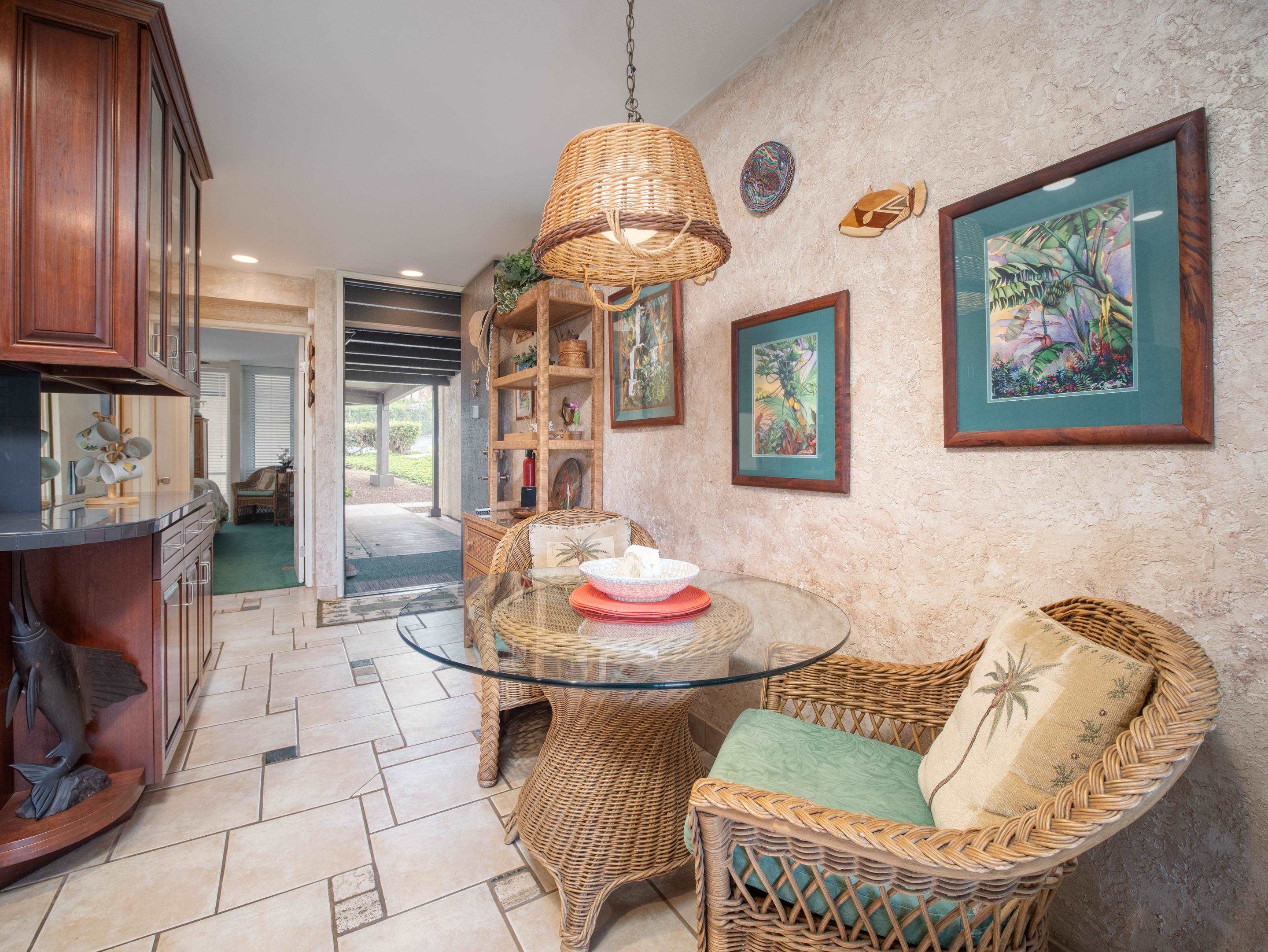 2737 South Kihei Road, Unit 1119 Kihei, HI 96753 - Photo 5 of 24 a dining room with furniture and a chandelier