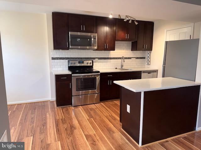 a kitchen with a sink and a stove top oven