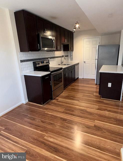 2 Normandy Square Court, Unit D Silver Spring, MD 20906 - Photo 6 of 32 a kitchen with stainless steel appliances kitchen island granite countertop a stove and a sink
