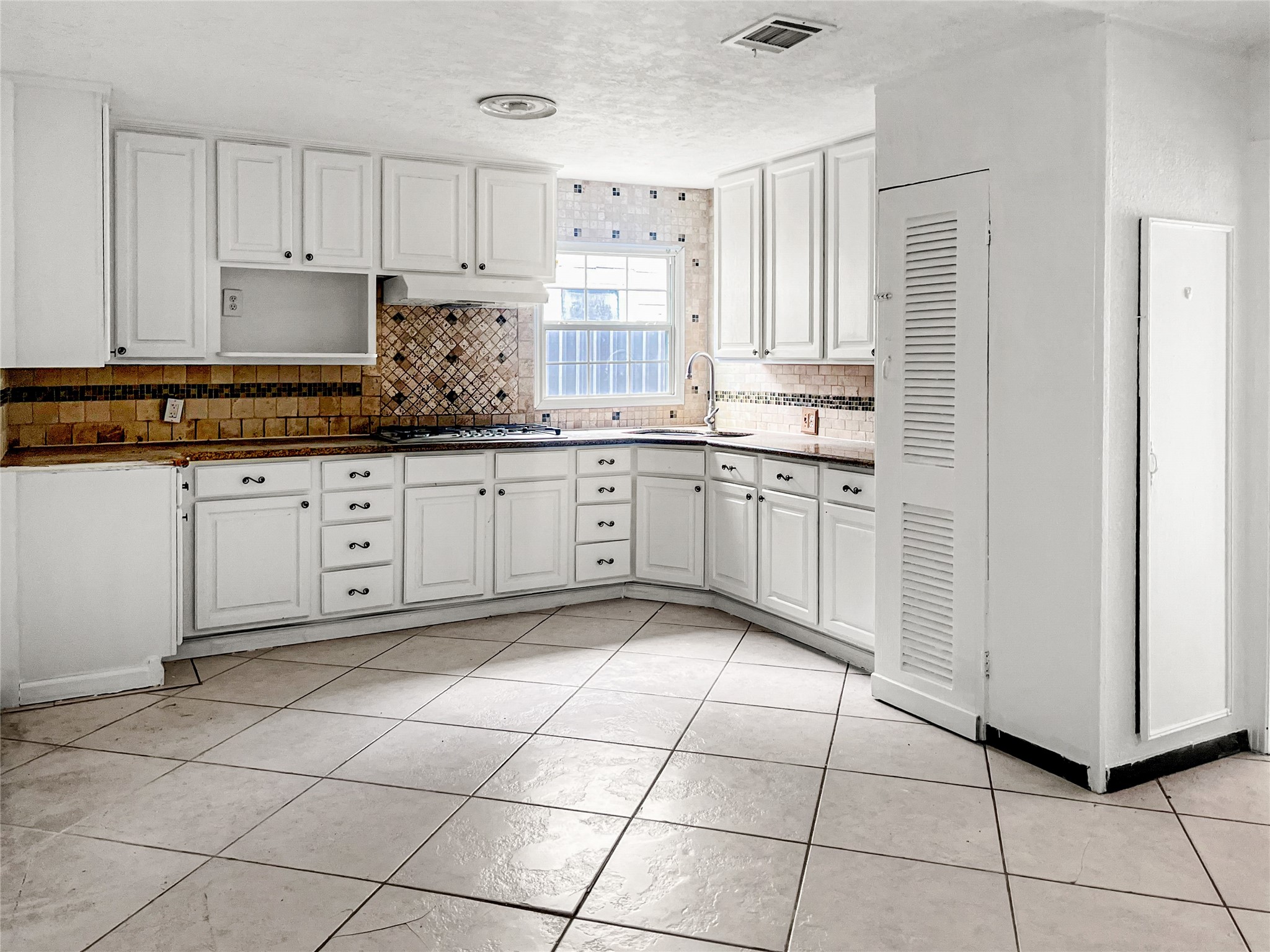 4803 Robertson Street Houston, TX 77009 - Photo 3 of 4 a kitchen with a sink window and cabinets