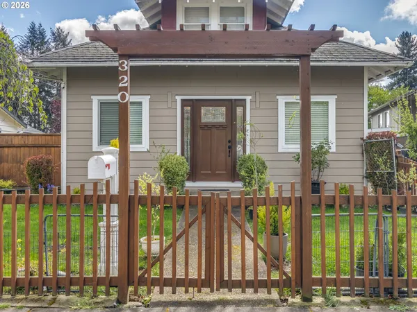 a front view of house with a garden