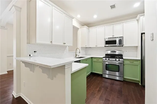a kitchen with a sink a stove and cabinets
