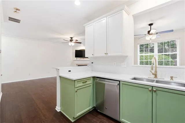 a kitchen with stainless steel appliances granite countertop a sink and dishwasher with wooden floor
