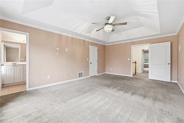 a view of an empty room with a ceiling fan