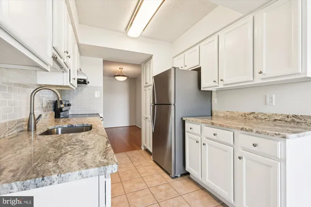 a large kitchen with stainless steel appliances granite countertop a stove and a sink