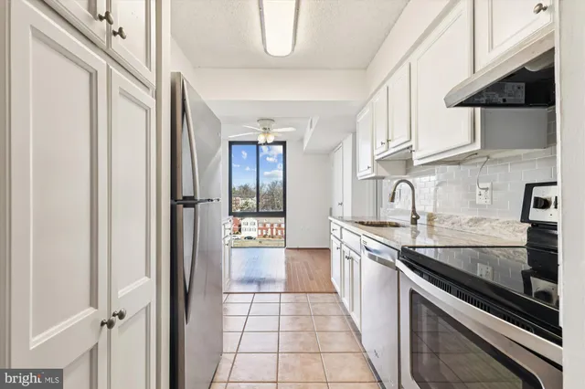 a kitchen with stainless steel appliances granite countertop a stove and a sink