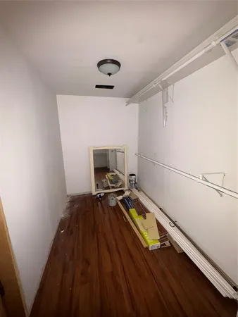 a walk in closet with empty racks