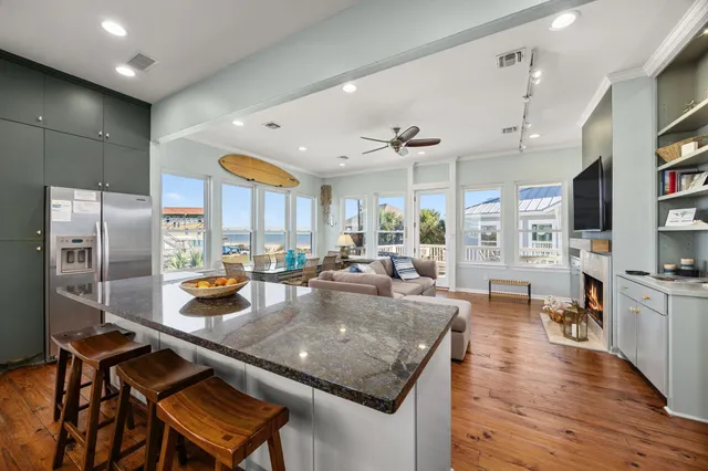 a kitchen with stainless steel appliances granite countertop a kitchen island a stove and a sink