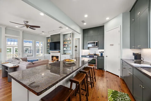 a kitchen with a stove a refrigerator and a dining table