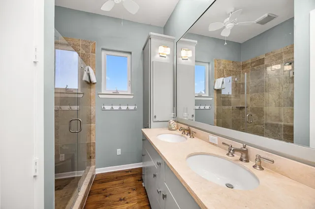 a bathroom with a sink a mirror a shower and a bathtub