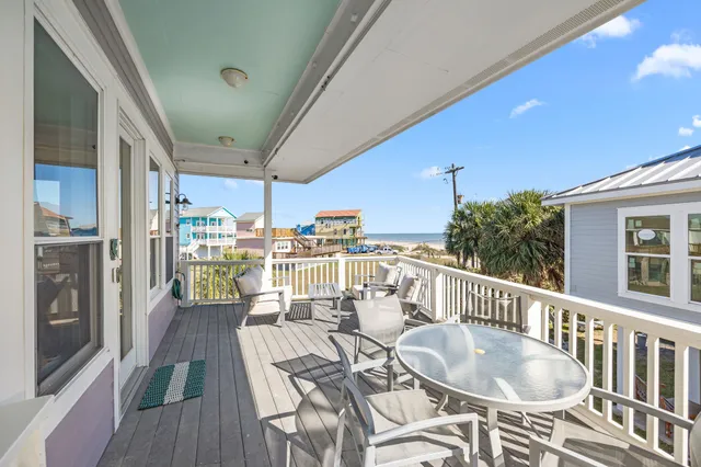a dining room with furniture window and wooden floor