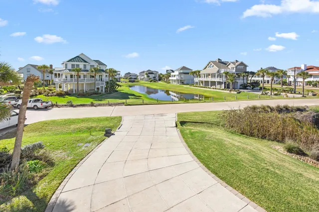 a view of a city with tall buildings and a big yard with plants