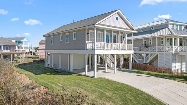 a view of a house with wooden fence