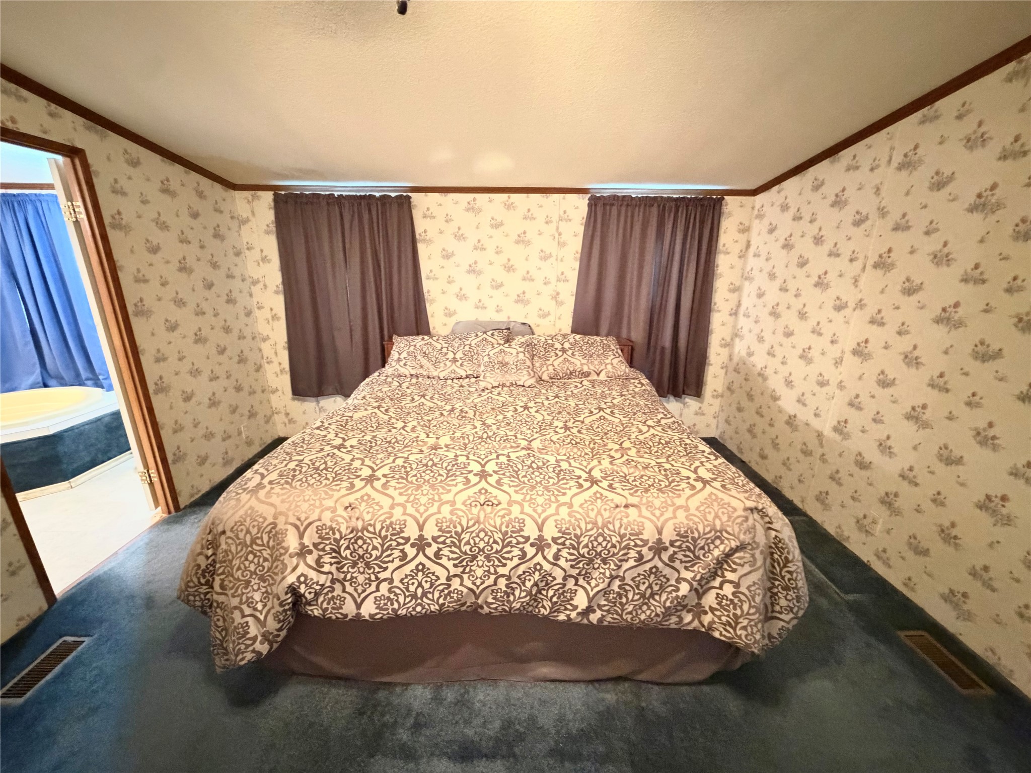 153 Prairie Lea Drive Angleton, TX 77515 - Photo 23 of 30 a bed sitting in a bathroom next to a window