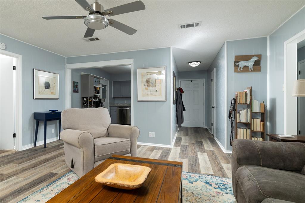 6020 Harrison Way Watauga, TX 76148 - Photo 14 of 32 Living area featuring light wood-style flooring and ceiling fan